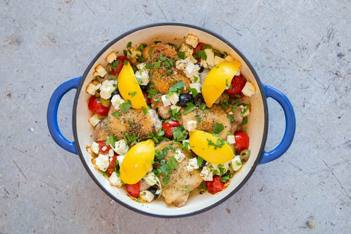 The baked Greek chicken sprinkled with chopped parsley to serve.