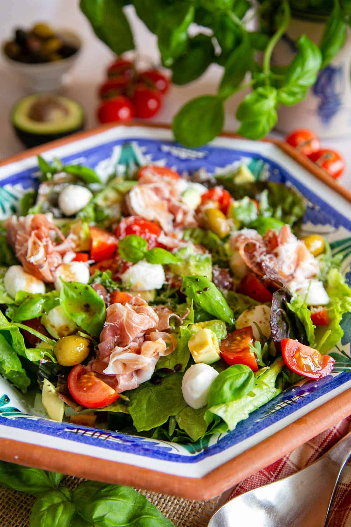 A delicious Italian style green salad, topped with fabulous antipasti, ready to serve.