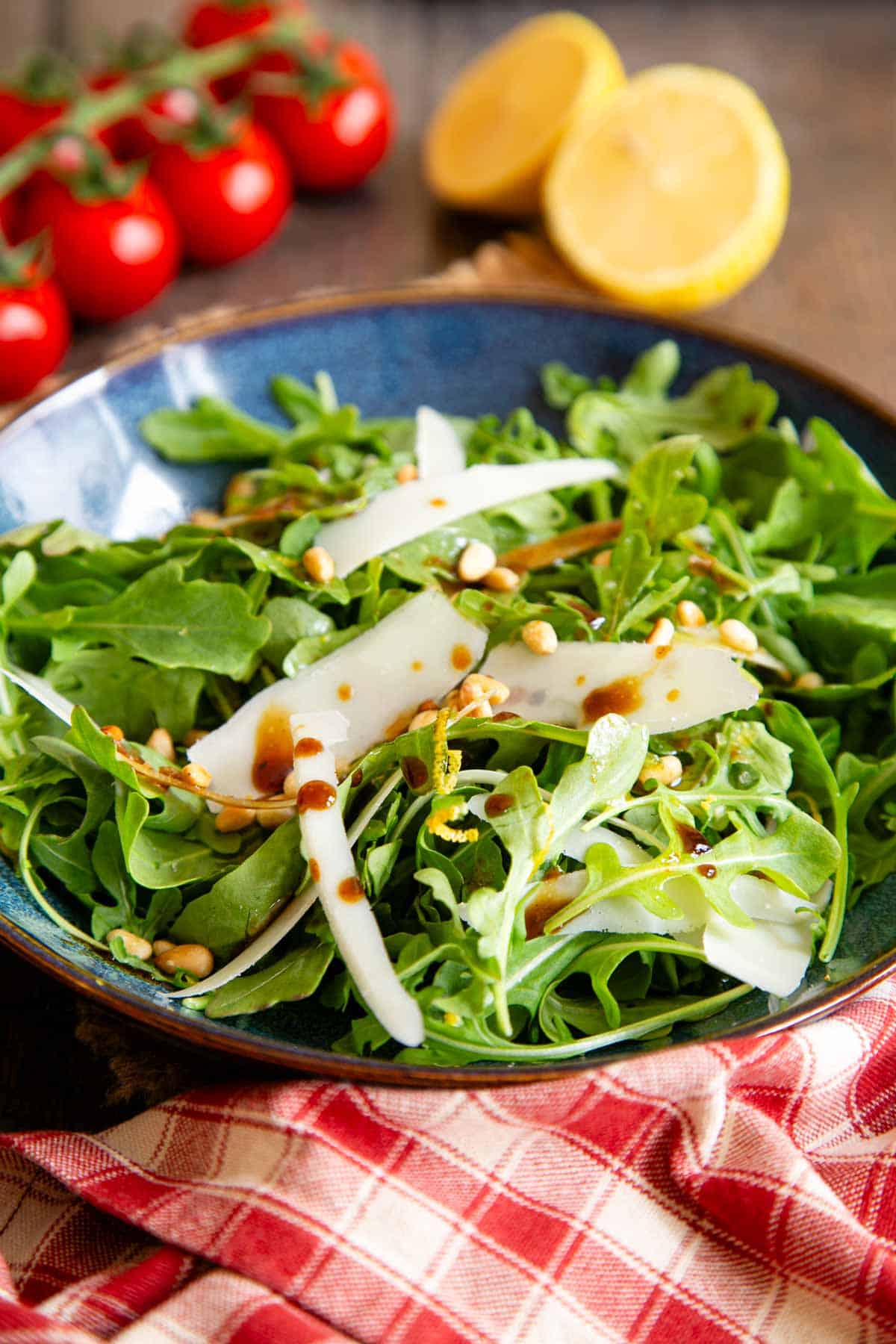 Fresh and vibrant, green rocket or arugula salad with parmesan shavings, pine kernels and a drizzle of balsamic dressing.