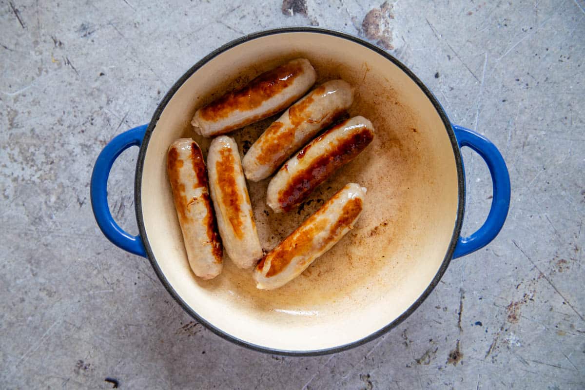 Browning the sausages in the casserole dish.