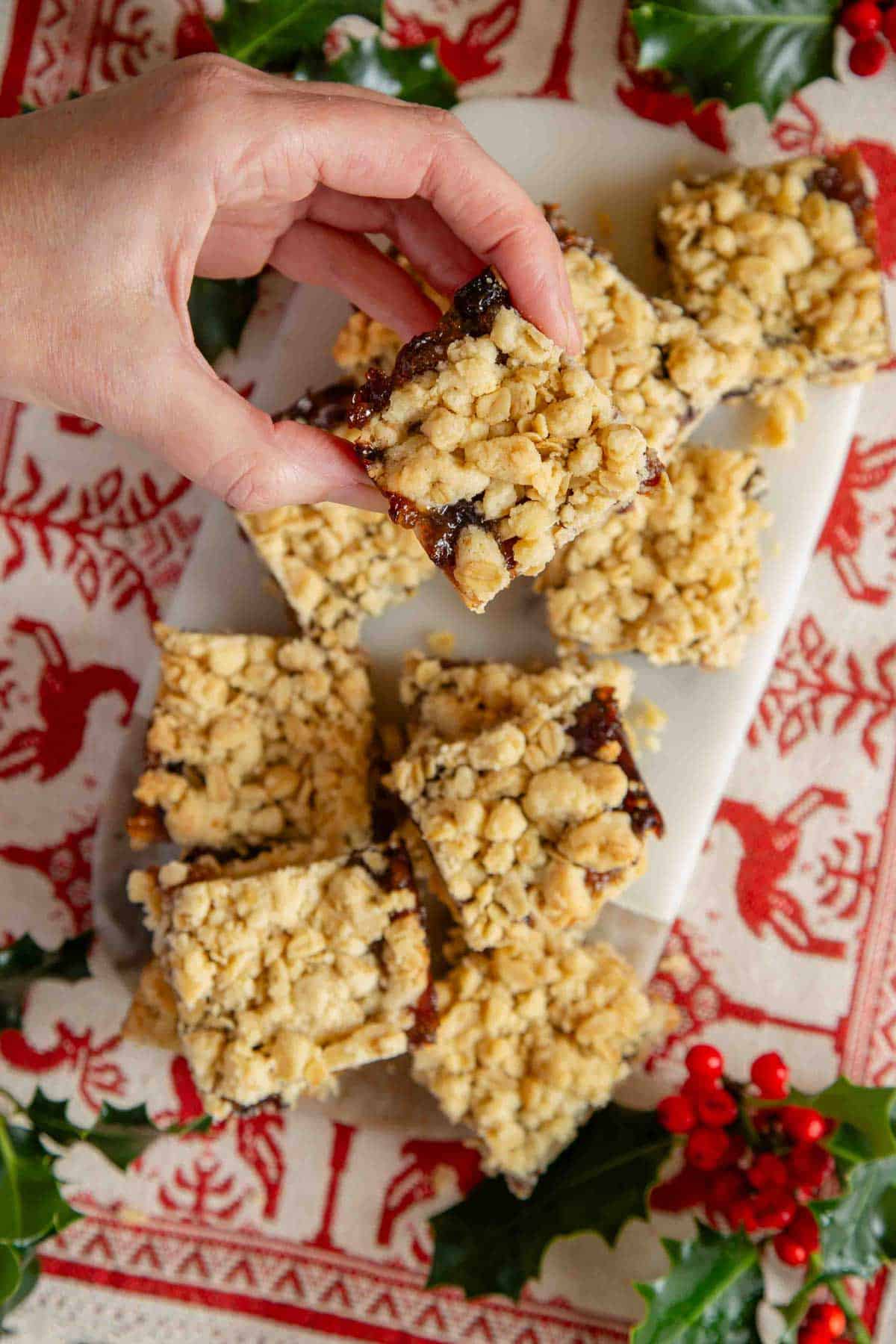 Taking a mincemeat crumble bar from a festive display.