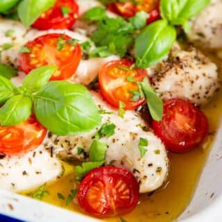 Italian chicken with cherry tomatoes and basil surrounded delicious natural juices.