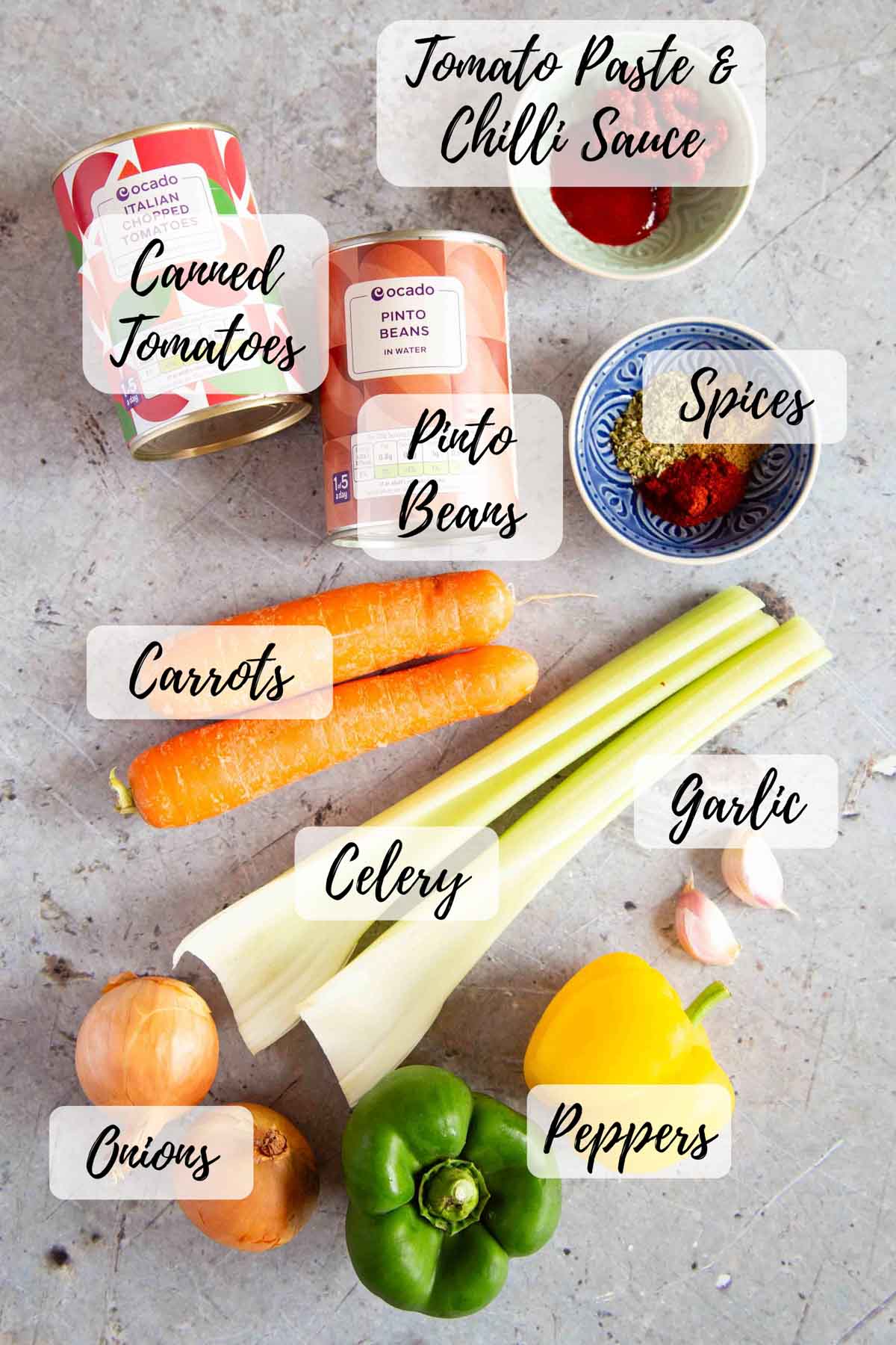 The ingredients: tomato paste and chilli sauce, spices, celery, garlic, peppers, onions, carrots, canned pinto beans and canned tomatoes.