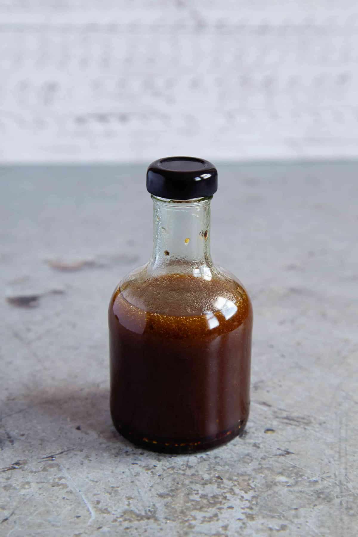 The dressing shaken up and emulsified in the bottle.