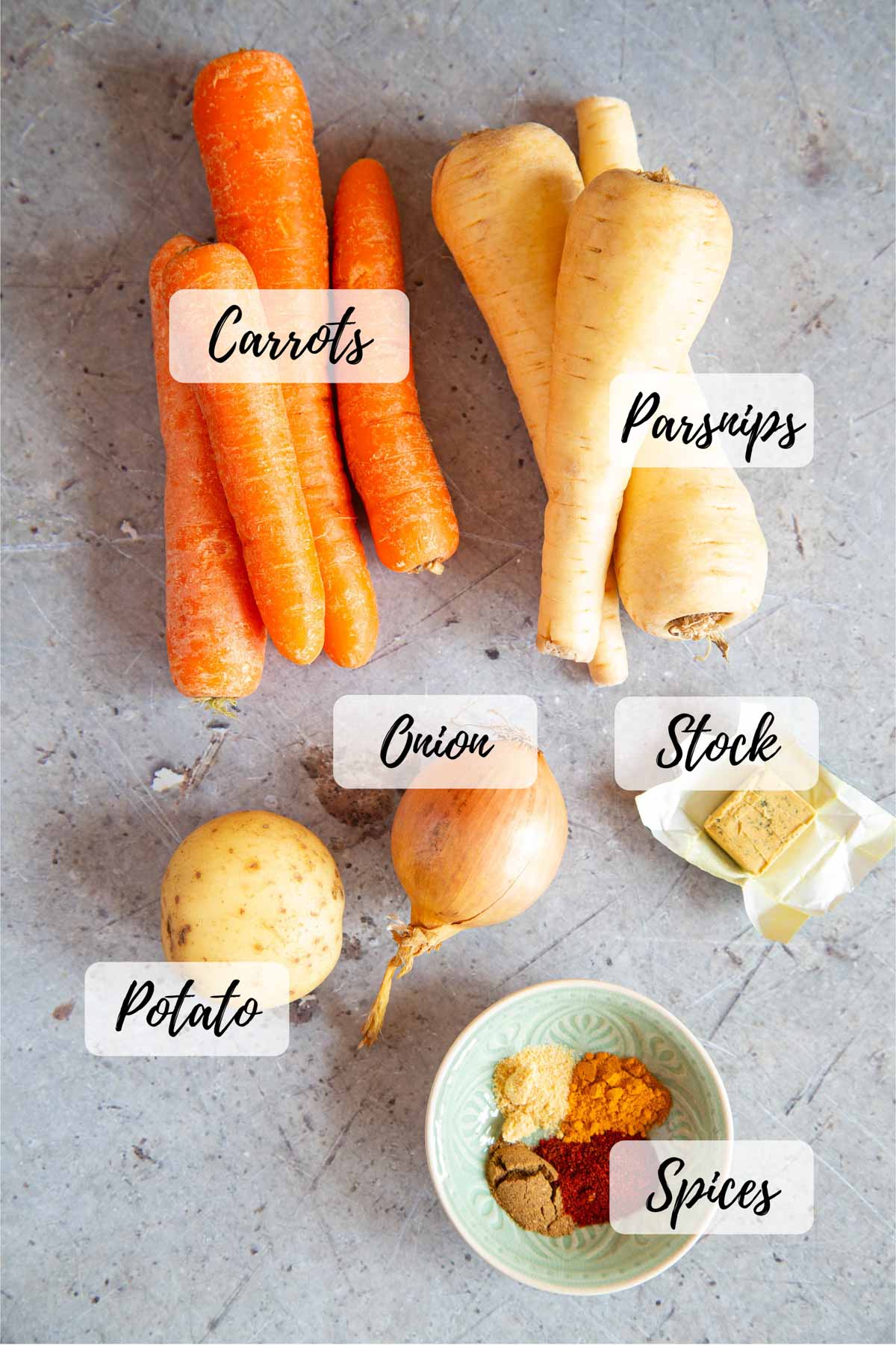 Ingredients for carrot and parsnip soup laid out on a table ready for cooking