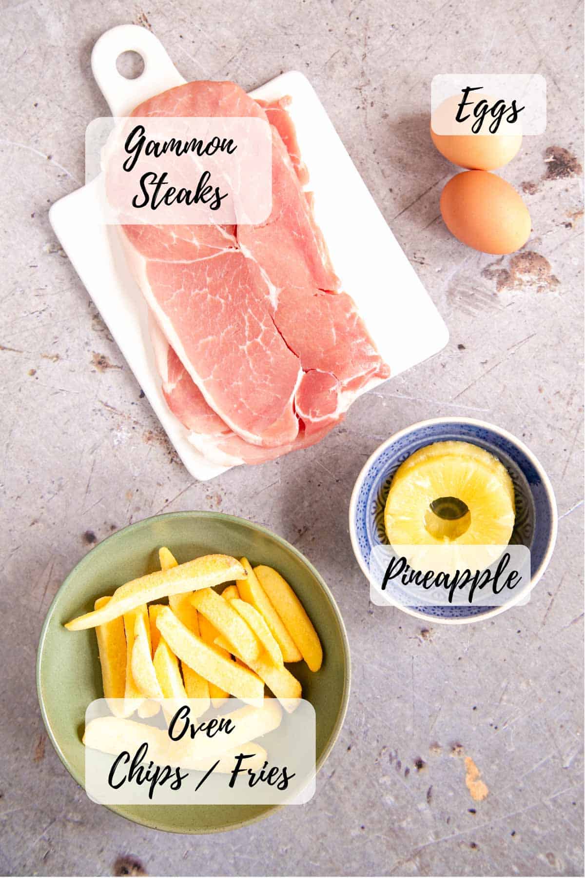 Ingredients for pub style ham egg and chips with pineapple text overlay labels each one