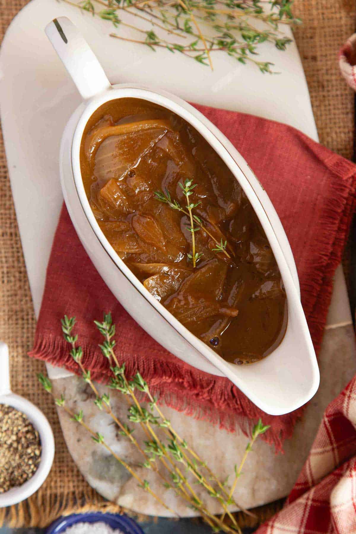 a gravy boat of thick onion gravy ready to enjoy