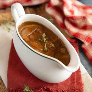a gravy boat of thick onion gravy ready to enjoy