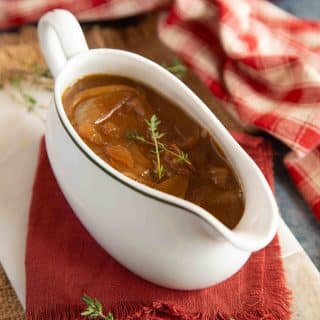 a gravy boat of thick onion gravy ready to enjoy