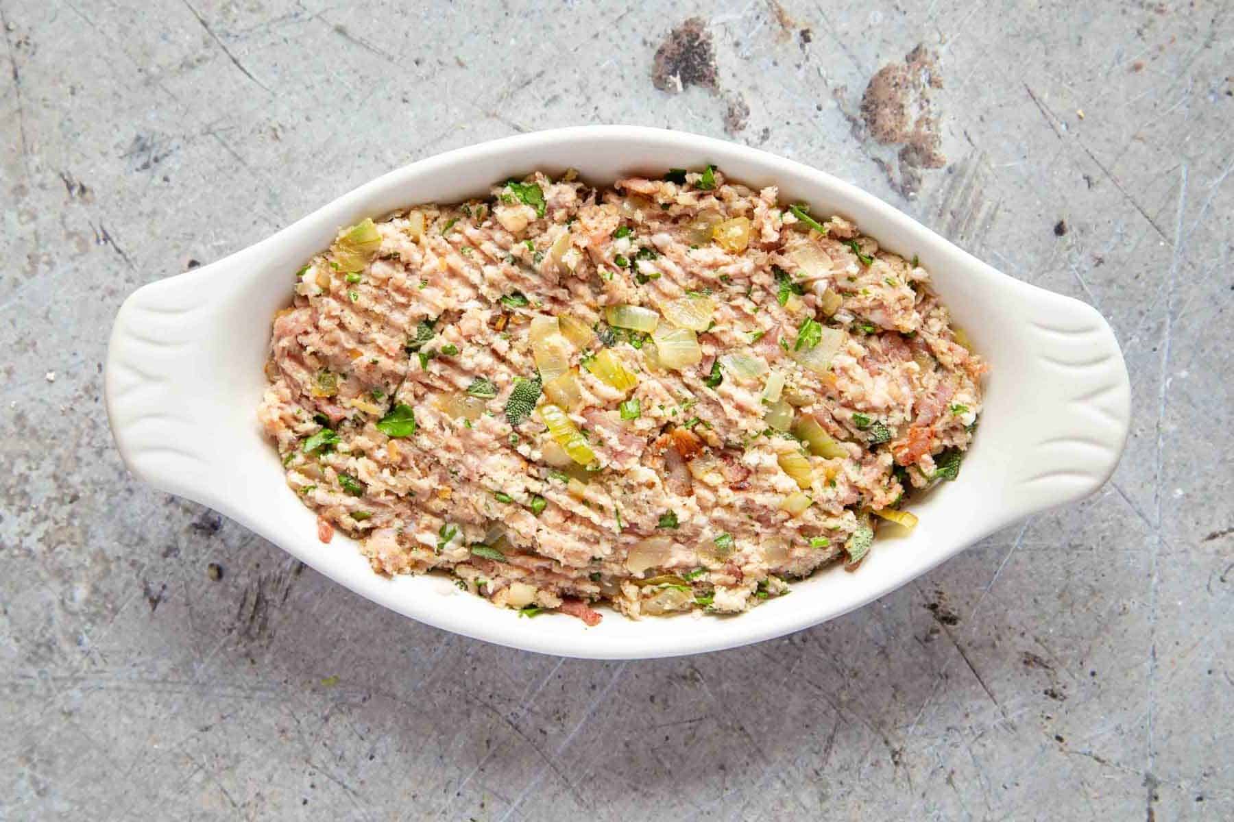 the raw stuffing is packed into a gratin dish ready to be cooked