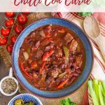 a bowl of freshly cooked chilli con carne surrounded by the traditional chilli toppings