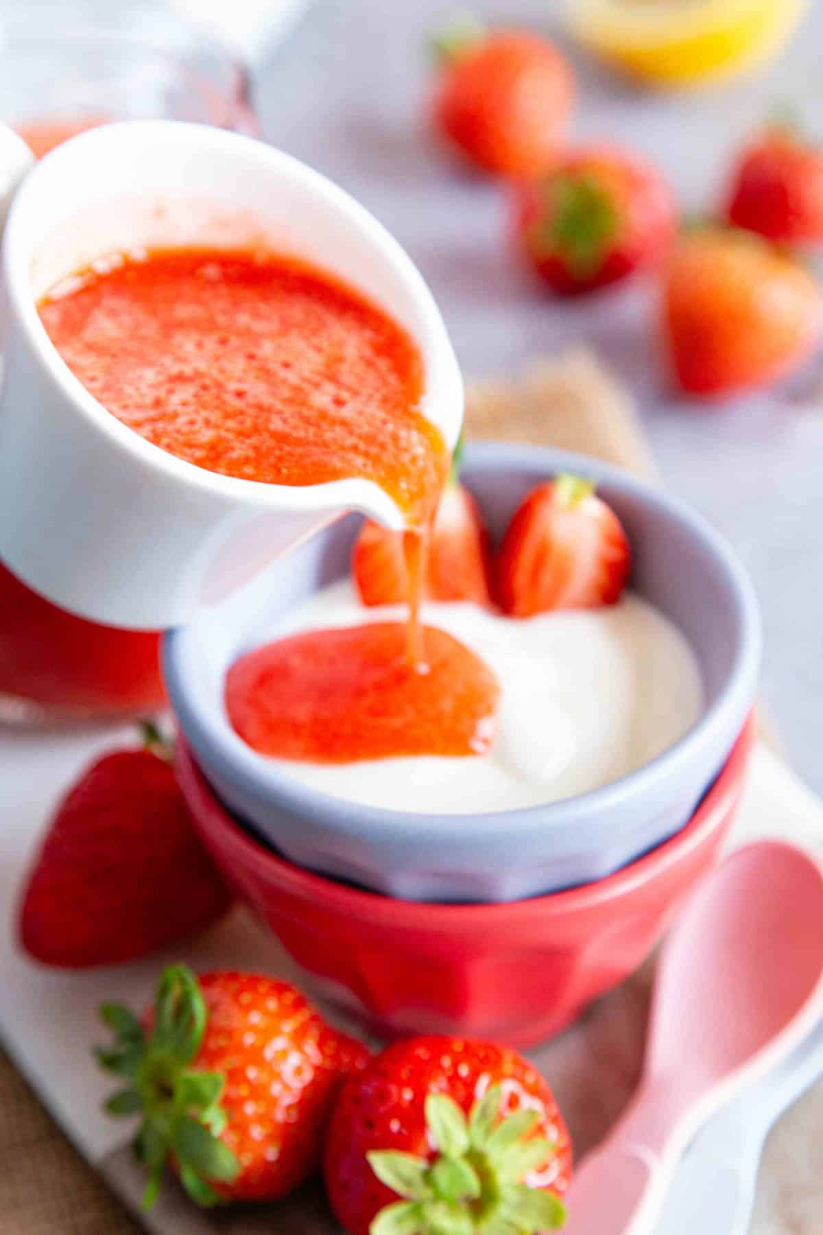 pouring the freshly made puree over some yoghurt