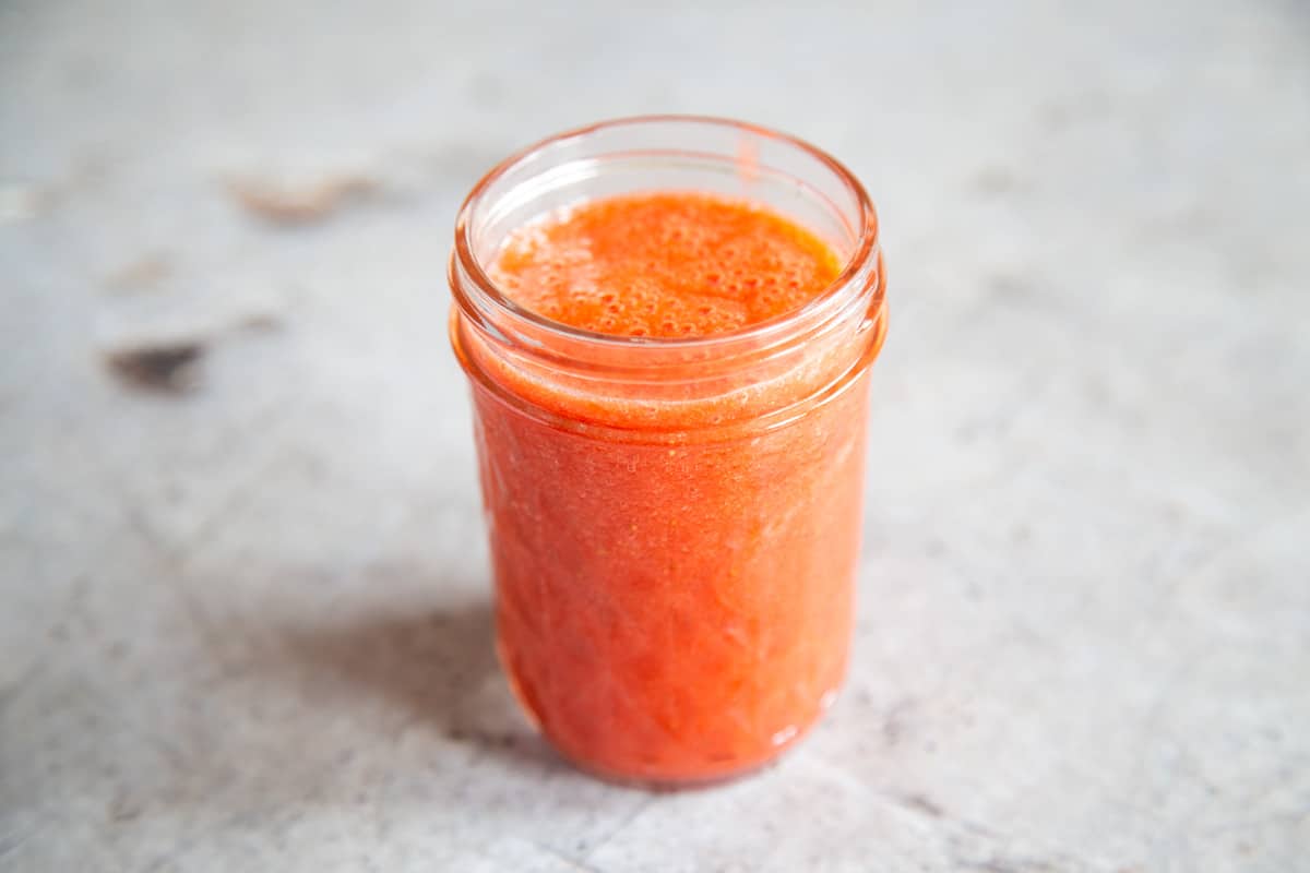 a jar of freshly prepared strawberry coulis