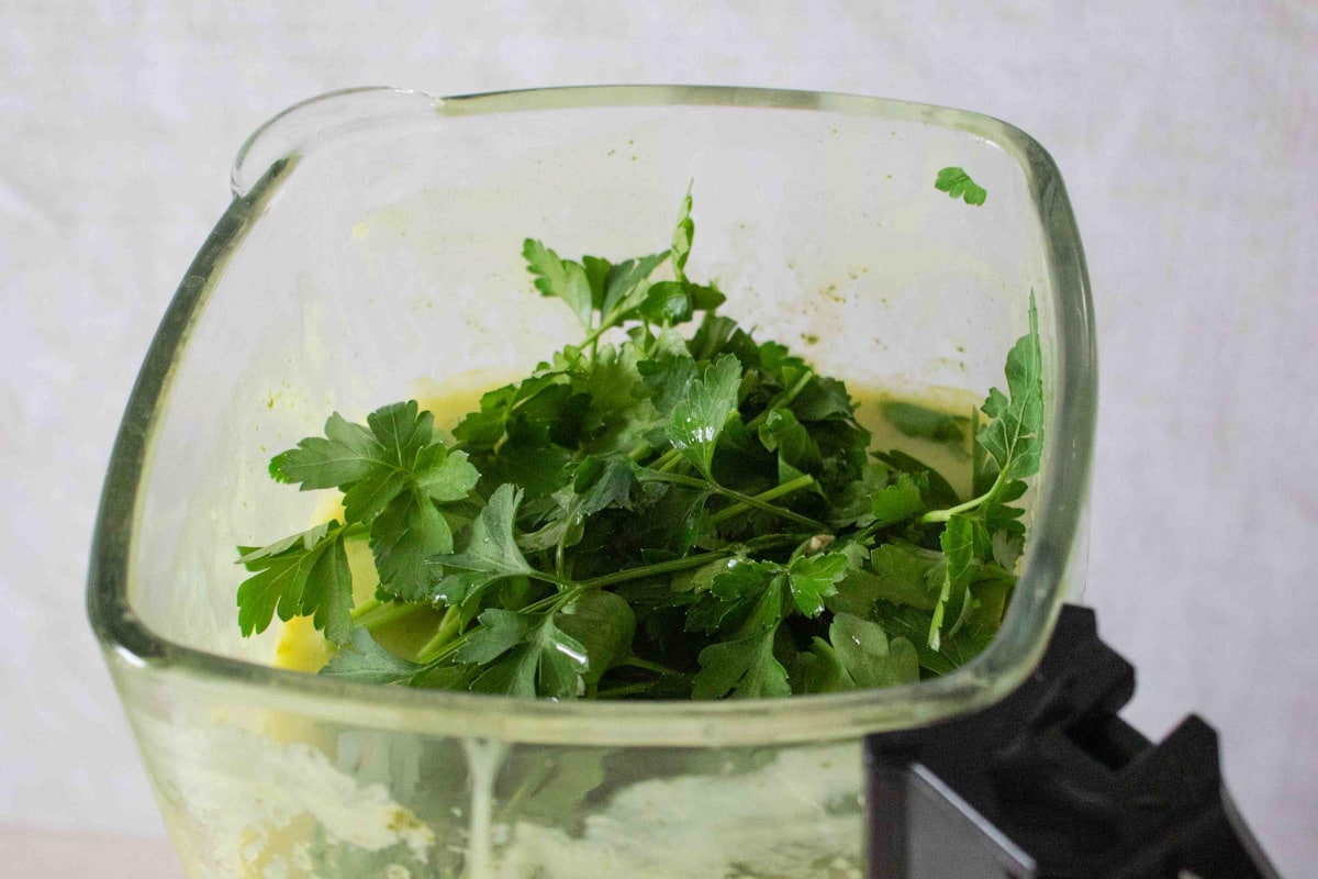 fresh parsley has been added to the soup maker before being pulsed in