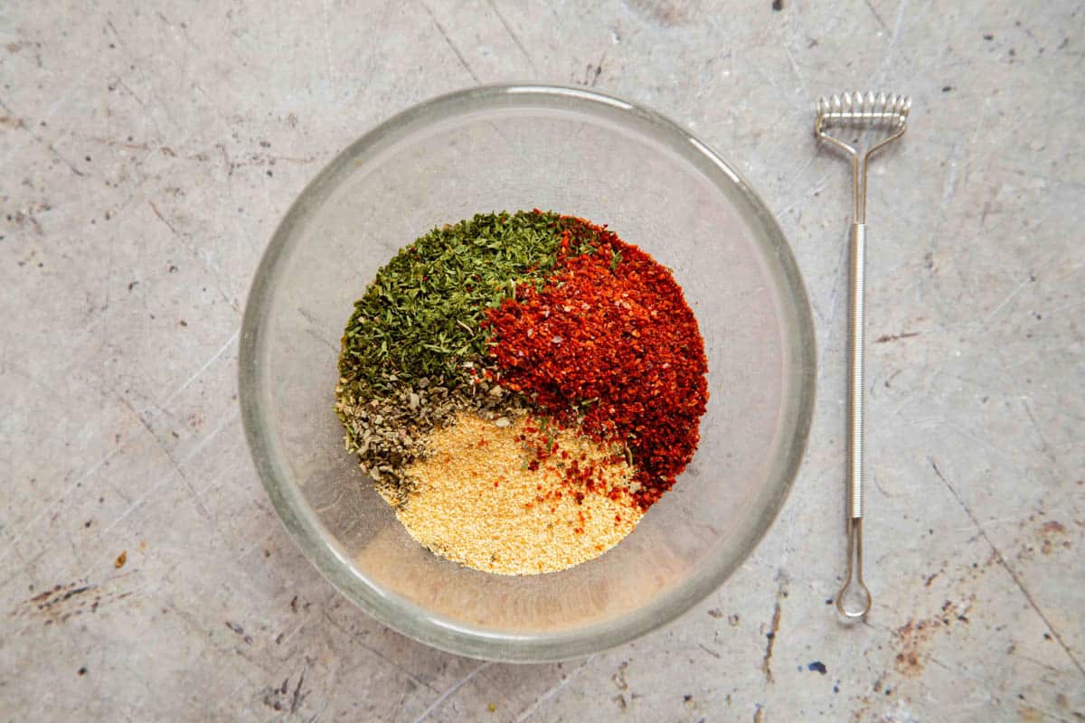 ingredients for Mediterranean seasoning in a bowl ready to be mixed