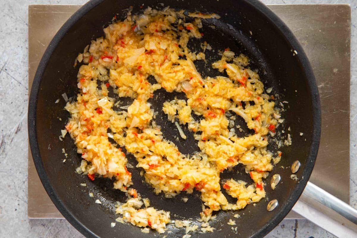 the onion, chilli, ginger and garlic have been fried until golden and fragrant