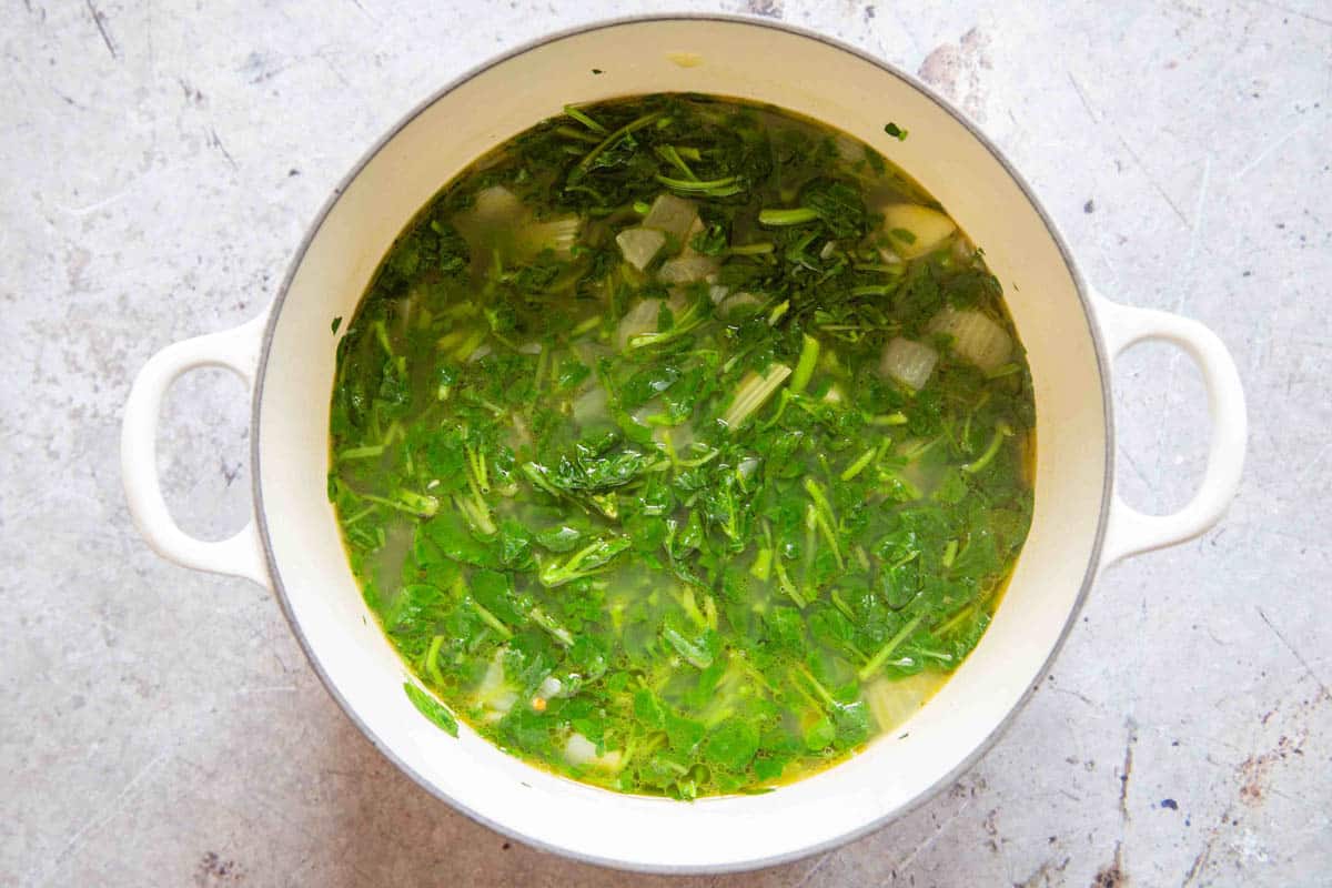 the chopped watercress has been added to the soup and briefly cooked to wilt it