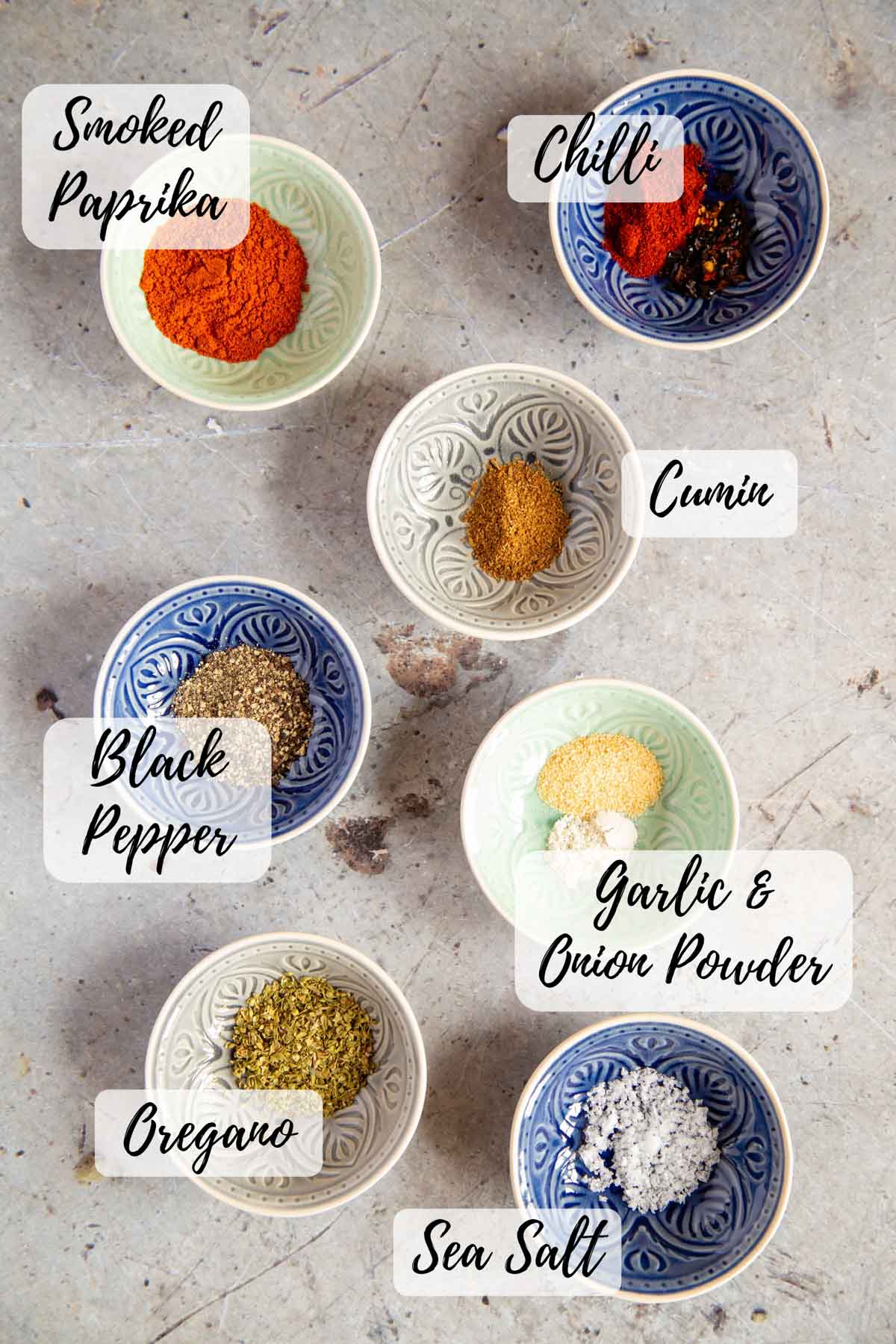 ingredients for taco seasoning measured into prep bowls ready to mix