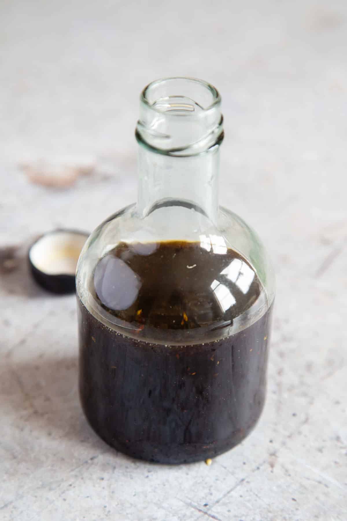 a glass bottle containing the freshly made dressing