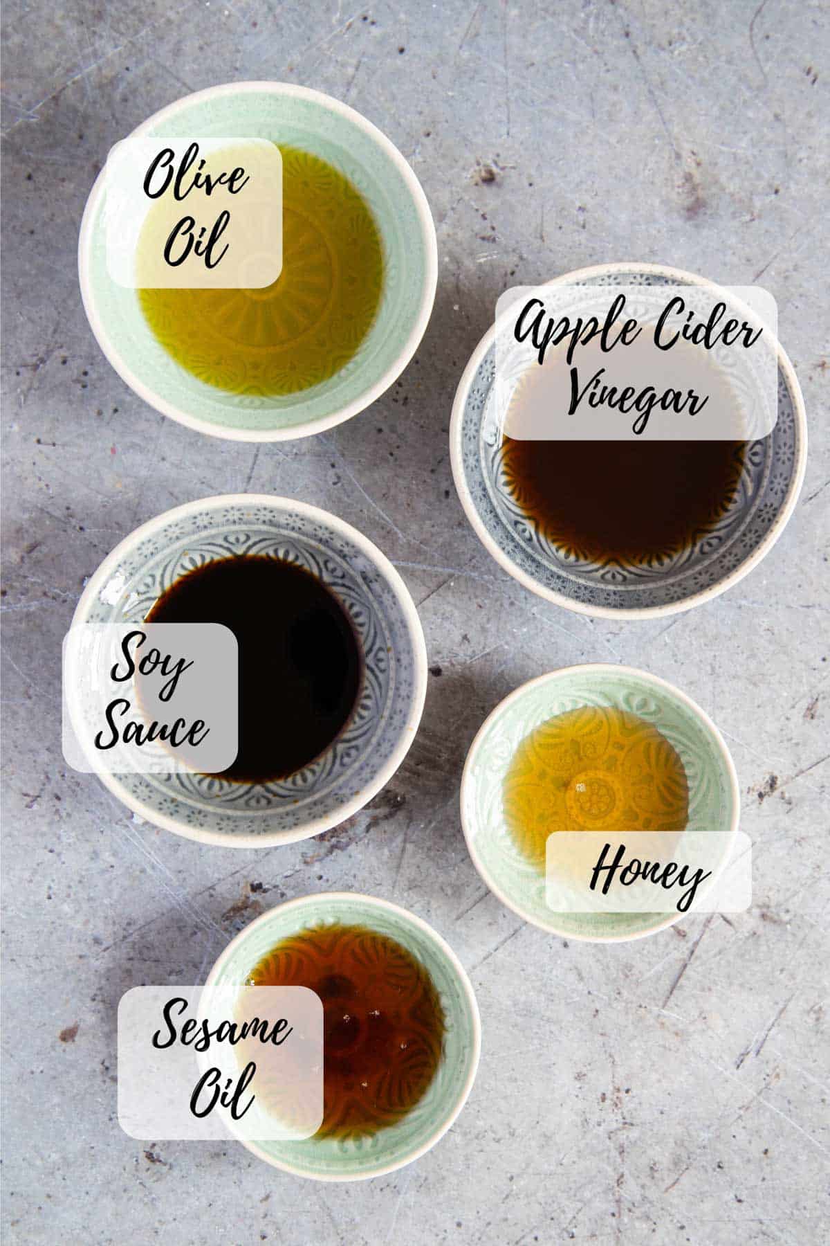 the five ingredients for Asian dressing measured out ready to prepare the dressing