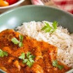 a bowl of quick chicken curry served with steamed rice and a tomato salad