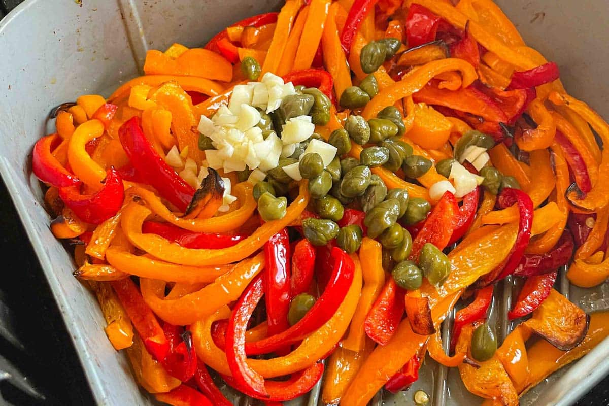 cooked peppers with garlic and capers in an air fryer liner