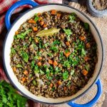 Braised Puy lentils in a white and blue shallow casserole dish