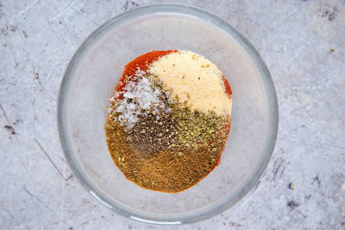 The ingredients for fajita seasoning in a bowl ready to be mixed