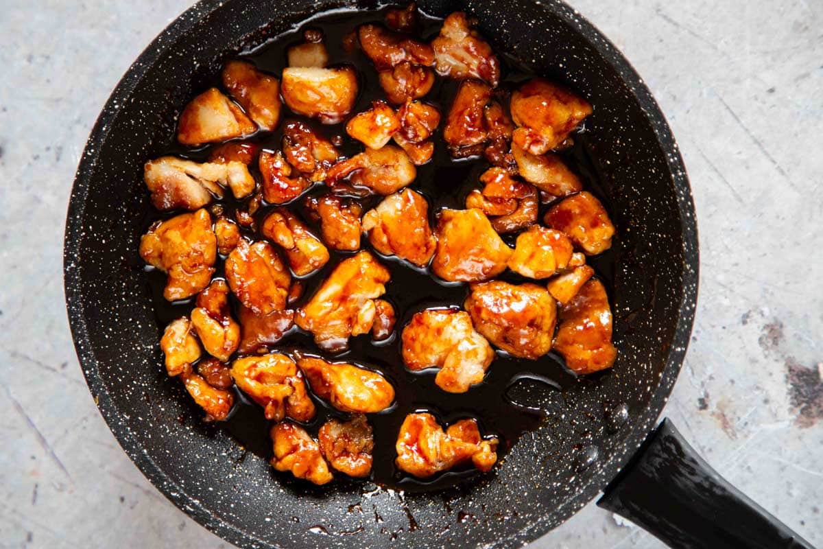 Golden brown pieces of cooked honey chilli chicken ready to serve