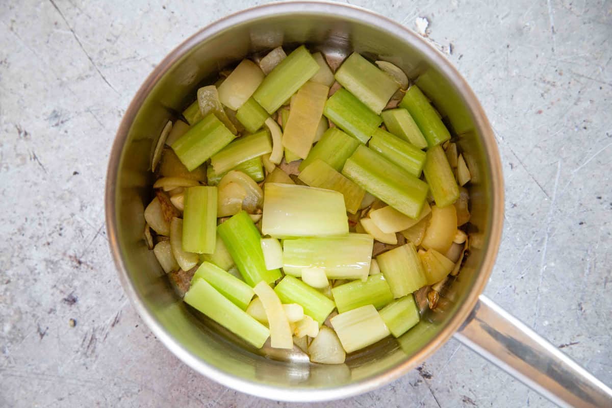 the onion garlic and celery are fried in a saucepan