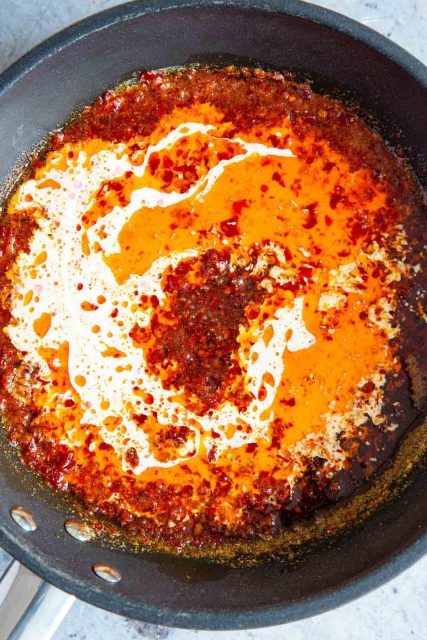 The cream and lemon juice is added to the pan