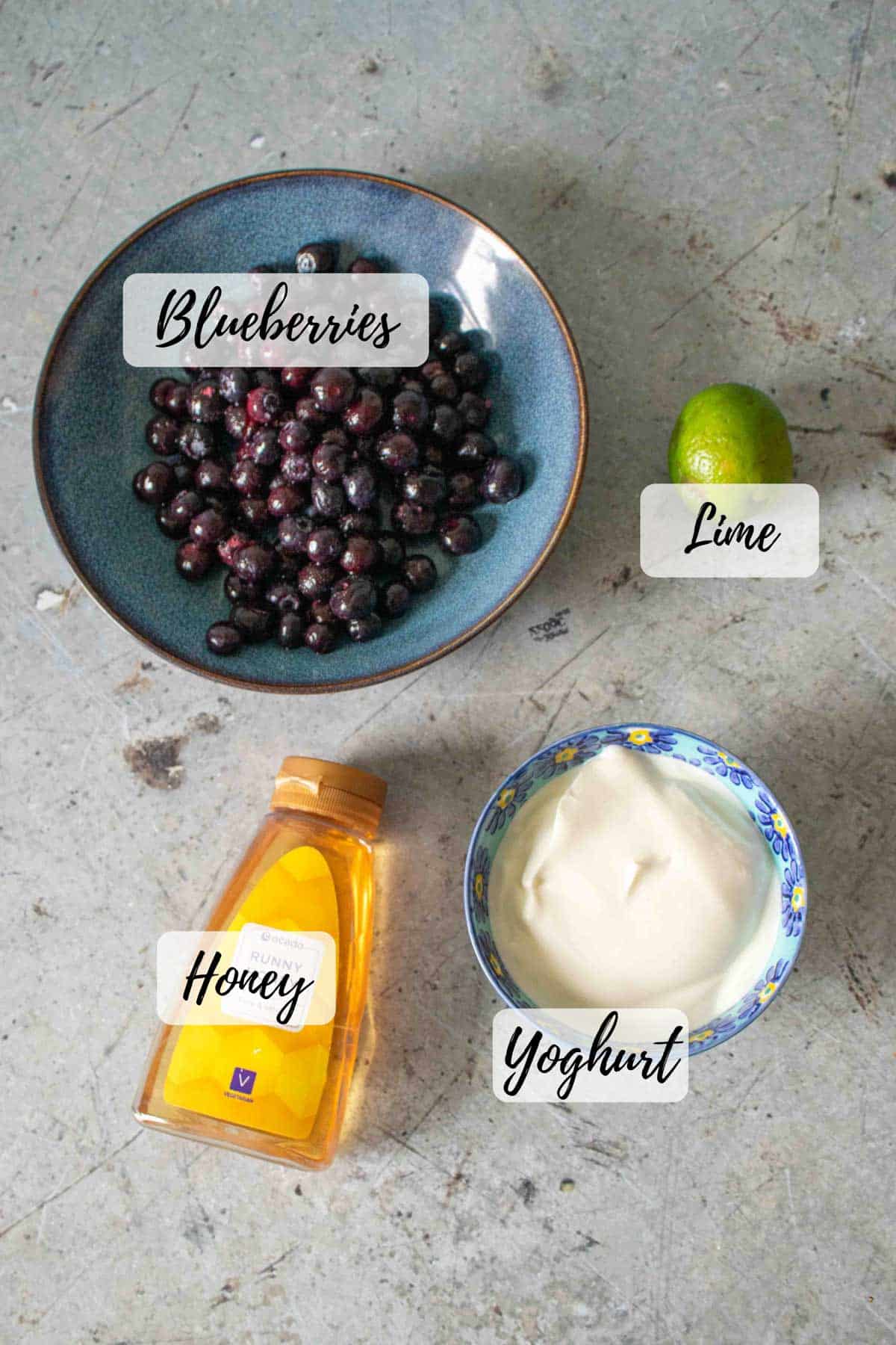 Ingredients are blueberries yoghurt honey and a lime