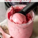 A scoop of raspberry frozen yoghurt being taken from a ninja creami pot.