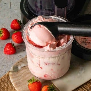 Ninja Creami frozen yoghurt in the pot with fruit surrounding