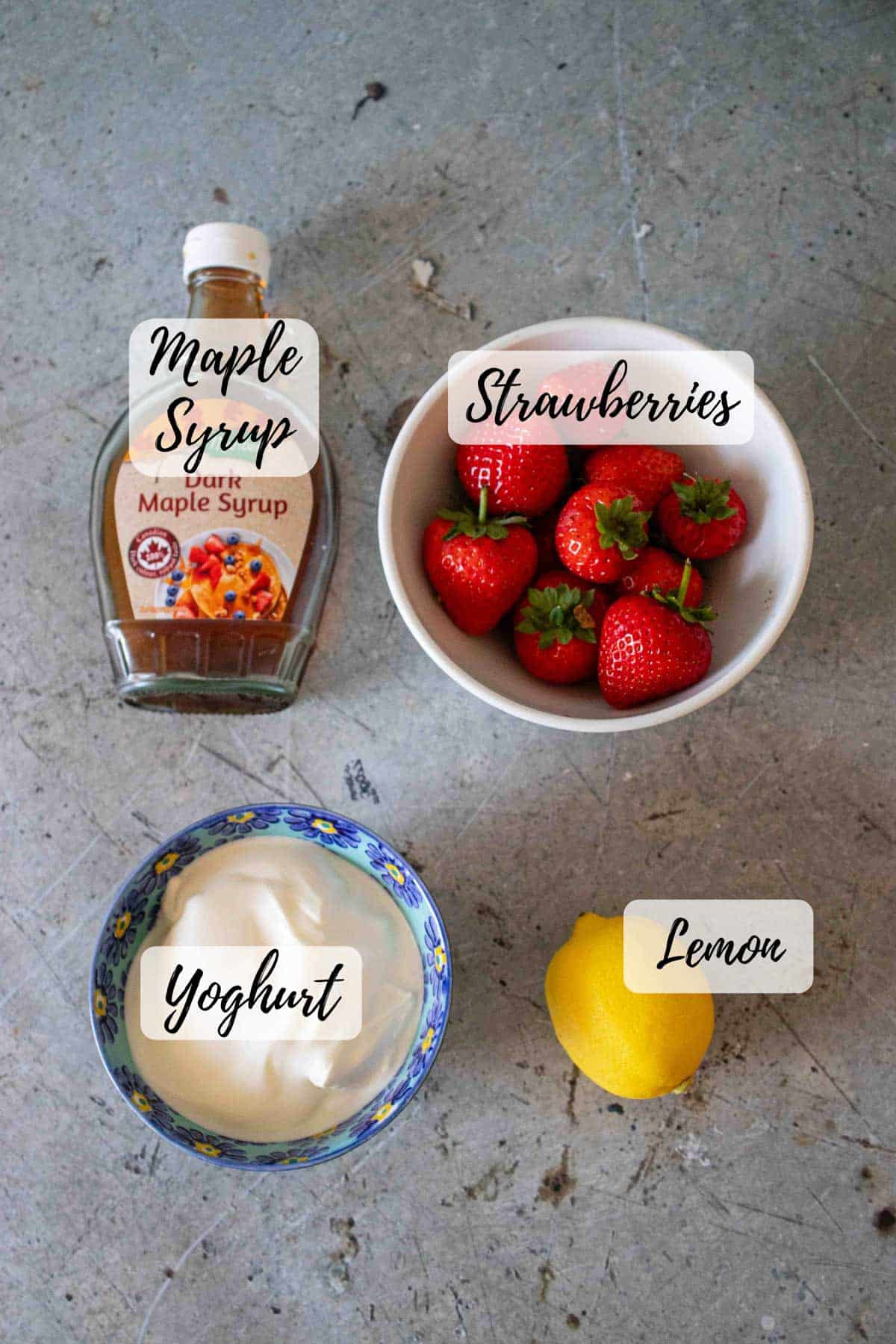 Ingredients are fresh strawberries yoghurt maple syrup and lemon