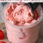 Scooping pale pink strawberry ice cream from the Ninja Creami pot