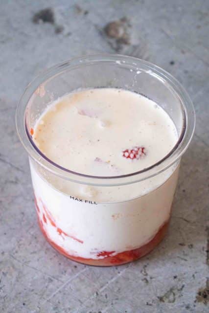 Ingredients for strawberry ice cream in the pot ready to be blended smooth