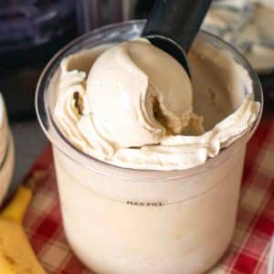 Close up of pale cream coloured banana ice cream being scooped out of a Ninja Creami pot