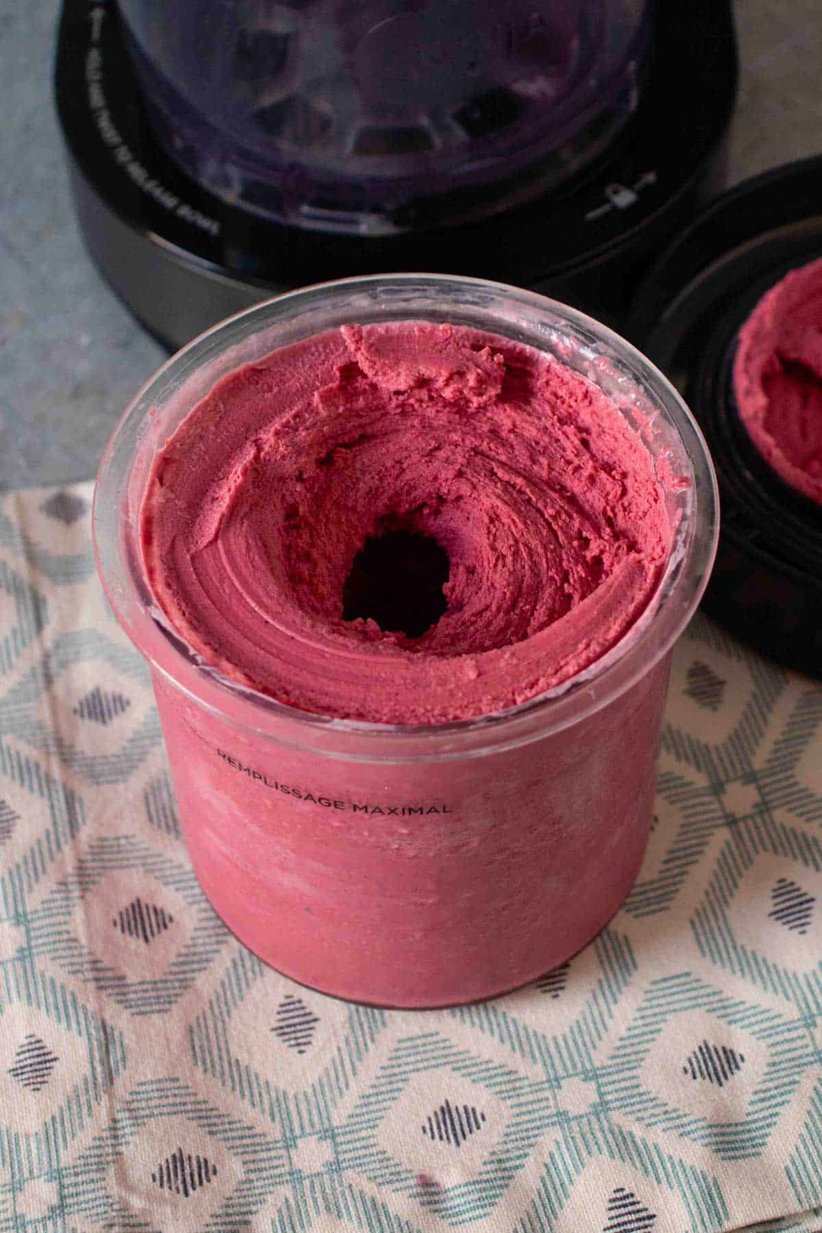 Mixed berry frozen yogurt after a respin in the Ninja Creami showing how it has come together and a hole formed down the middle of the pot