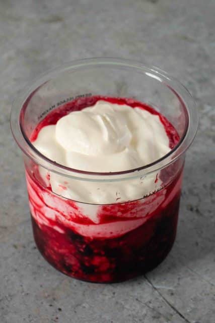 Fruit and yoghurt fill the Ninja Creami pot up to the max fill line