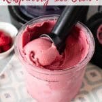 Ninja Creami raspberry ice cream in the Ninja pot with a scoop being removed