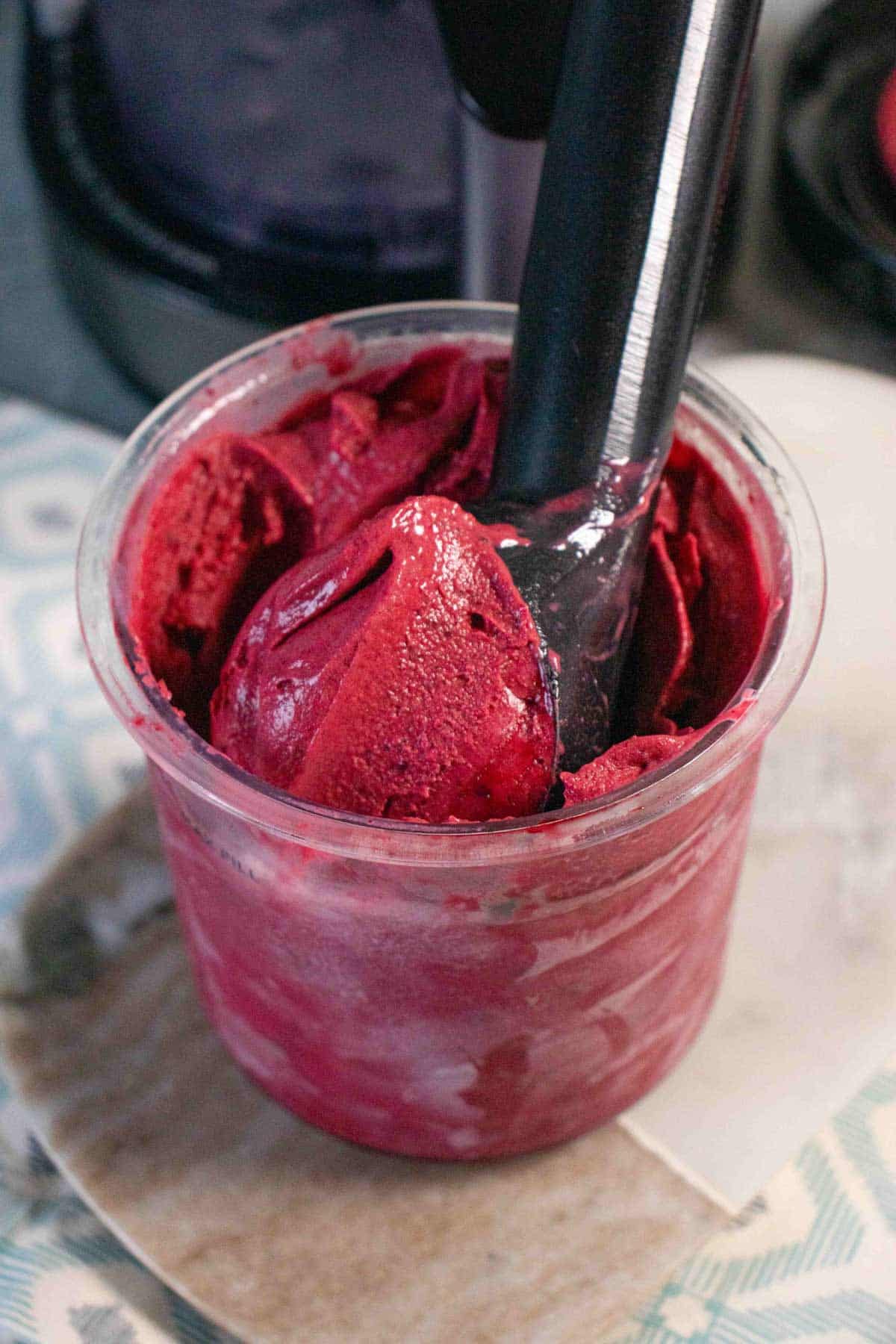 An ice cream scoop taking a serving of ice cream from the Ninja Creami pot