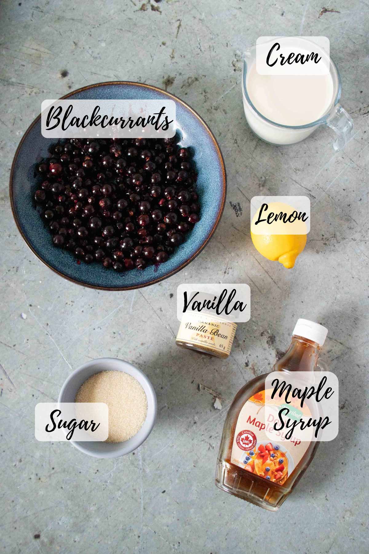 The ingredients are blackcurrants cream vanilla paste sugar maple syrup and a lemon