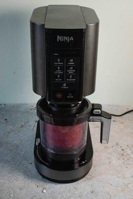 The Ninja Creami loaded with a pot of ice cream that's ready to spin
