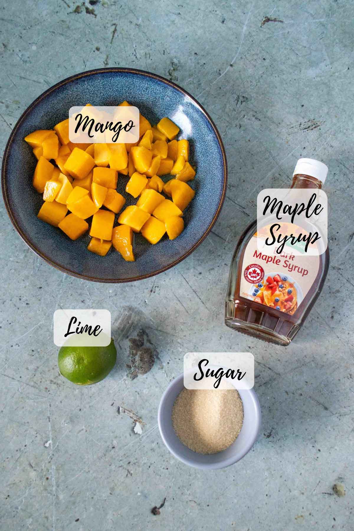 Ingredients are mango chunks maple syrup lime and sugar