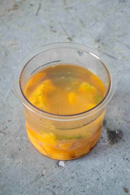 Ninja pot full of mango sorbet ingredients ready to blend