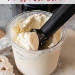 Pale cream coloured vanilla ice cream being scooped from the pot