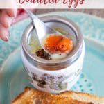 A freshly-cooked coddled egg served in an egg coddler with a spoon the yolk soft and melting, seasoned with salt and pepper