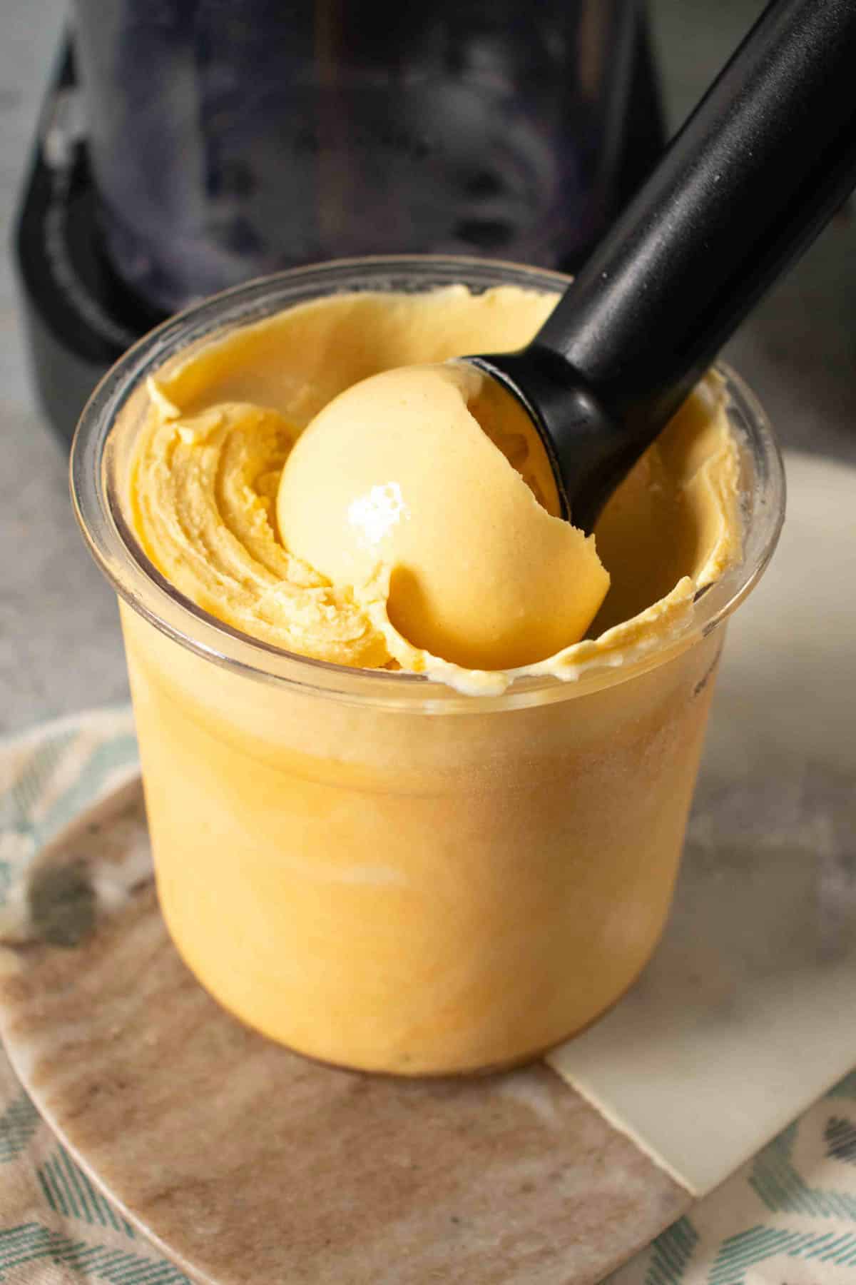 Passion fruit frozen yoghurt fills a Ninja Creami pot