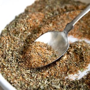 a close up view of a spoon resting in a dish of the seasoning